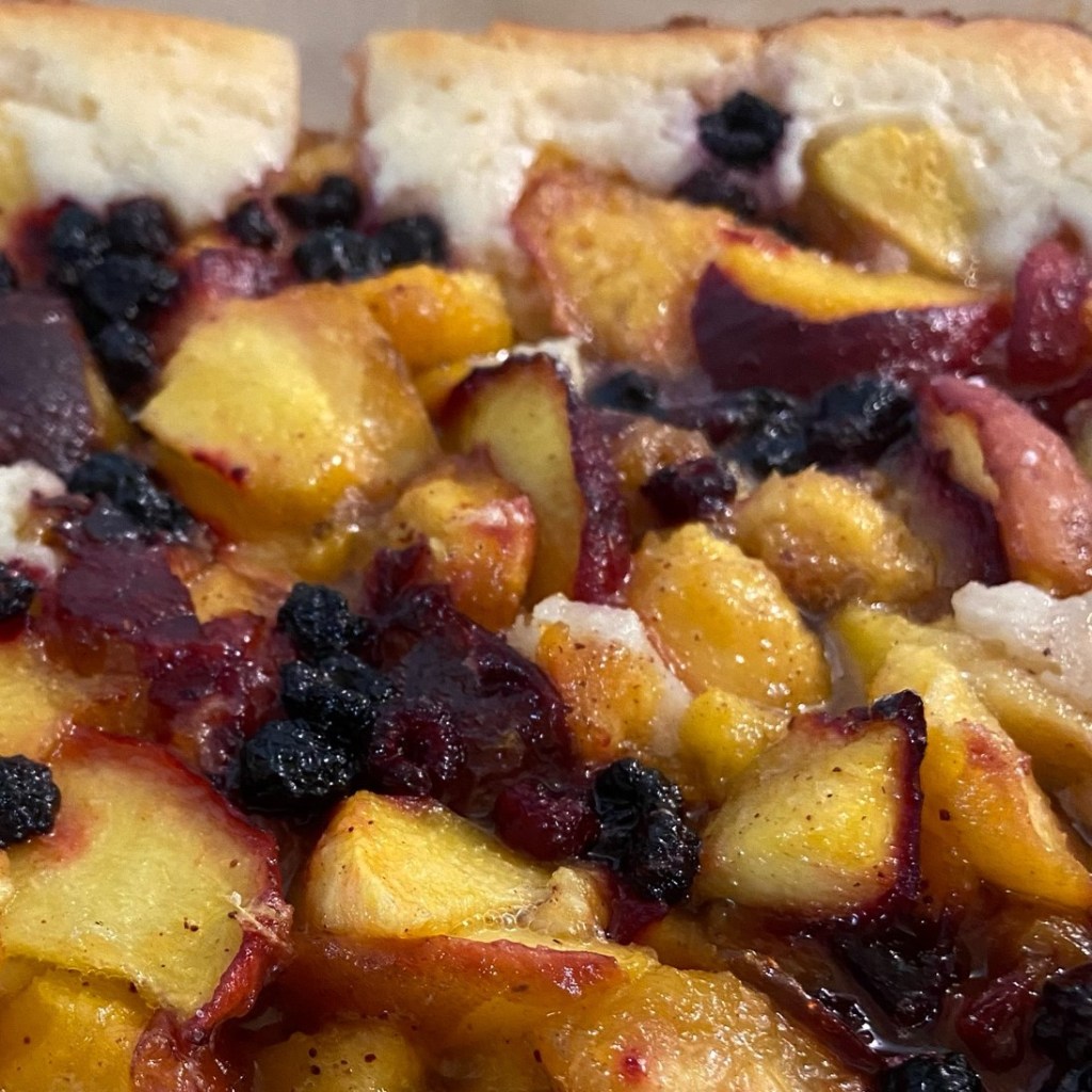 Juicy peach cobbler with golden topping.